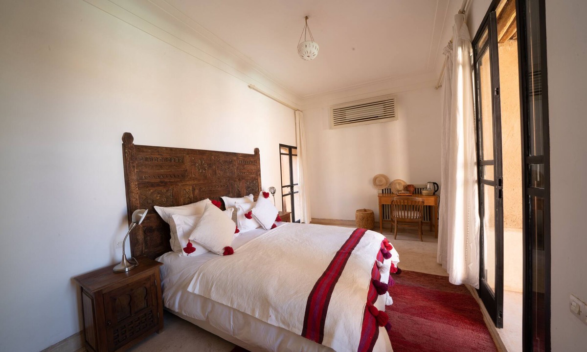 Oumnass House | Pool-view romantic bedroom