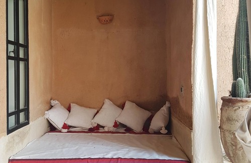 Oumnass House | Pool-view romantic bedroom