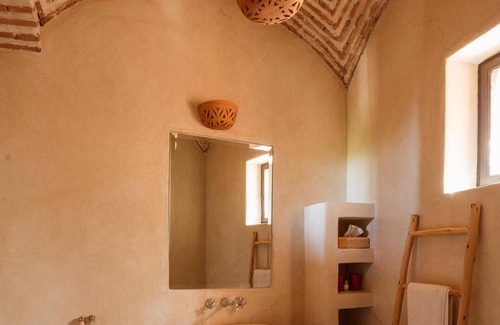 Oumnass House | Pool-view romantic bedroom